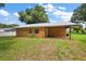Orange house with metal roof and green lawn at 10367 Se Sunset Harbor Rd, Summerfield, FL 34491