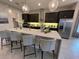 Modern kitchen with dark cabinetry, granite countertops, and stainless steel appliances at 10068 Fiddley Aly, Orlando, FL 32827