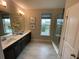 Elegant bathroom with double vanity and large shower at 10068 Fiddley Aly, Orlando, FL 32827
