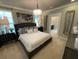 Spacious main bedroom with plush carpeting, large bed, and en-suite bathroom at 10068 Fiddley Aly, Orlando, FL 32827
