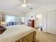 Spacious primary bedroom with access to a private bathroom and sliding glass doors to the patio at 4706 Glen Coe St, Leesburg, FL 34748