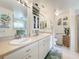 Elegant bathroom with double sinks, a large vanity and a walk-in shower at 4706 Glen Coe St, Leesburg, FL 34748