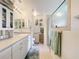 Clean bathroom with double vanity, shower, and ample storage at 4706 Glen Coe St, Leesburg, FL 34748