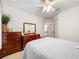 Well-lit bedroom featuring a double bed, wooden dresser and a mirrored vanity at 4706 Glen Coe St, Leesburg, FL 34748