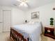 Bright bedroom with a double bed, wooden dresser, and access to a private bathroom at 4706 Glen Coe St, Leesburg, FL 34748