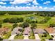 Aerial view of houses near a pond and conservation area at 4706 Glen Coe St, Leesburg, FL 34748