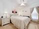 Well-lit bedroom with a queen-size bed and wooden dresser at 4706 Glen Coe St, Leesburg, FL 34748