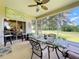 Covered patio with glass sliders, seating, and tranquil views at 4706 Glen Coe St, Leesburg, FL 34748