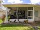 Enclosed porch with screened windows and ceiling fan at 4706 Glen Coe St, Leesburg, FL 34748