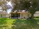 Spacious backyard with screened porch and mature trees at 4706 Glen Coe St, Leesburg, FL 34748