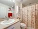 Clean bathroom with a shower/tub combo and seashell decor at 4706 Glen Coe St, Leesburg, FL 34748