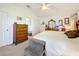 Large main bedroom with king bed, dresser, and plenty of closet space at 4706 Glen Coe St, Leesburg, FL 34748