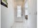 Bright entryway with tile flooring and glass-paned door at 4706 Glen Coe St, Leesburg, FL 34748