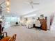 Spacious living room with light carpeting, and access to patio at 4706 Glen Coe St, Leesburg, FL 34748