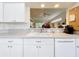 Kitchen with double sink, dishwasher, and view to living area at 4706 Glen Coe St, Leesburg, FL 34748