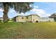 View of manufactured home from backyard, showing side and screened porch at 1605 W Schwartz Blvd, The Villages, FL 32159