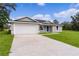 Single story home with attached garage and driveway at 5 Malauka Radial Run Rd, Ocklawaha, FL 32179