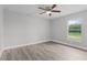 Spacious bedroom with ceiling fan and large window at 5 Malauka Radial Run Rd, Ocklawaha, FL 32179