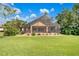 Large backyard with a screened enclosure, deck, and lush landscaping at 5008 Greenbriar Trl, Mount Dora, FL 32757