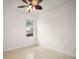 Bright, airy bedroom with tile floors, a ceiling fan and large window at 5008 Greenbriar Trl, Mount Dora, FL 32757