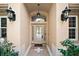 Inviting front entry with arched transom window and decorative tile walkway at 5008 Greenbriar Trl, Mount Dora, FL 32757