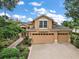 Two-story house with a two-car garage and landscaping at 5008 Greenbriar Trl, Mount Dora, FL 32757