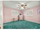 Bright bedroom with green carpet, ceiling fan, and double windows at 9823 Se 178Th Ln, Summerfield, FL 34491