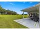 Covered patio with swing, overlooking a spacious grassy backyard at 9823 Se 178Th Ln, Summerfield, FL 34491