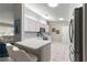 Kitchen with white cabinets, stainless steel appliances, and breakfast bar at 9823 Se 178Th Ln, Summerfield, FL 34491