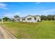 Single-story home with green awnings and expansive lawn at 9823 Se 178Th Ln, Summerfield, FL 34491