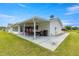 Covered patio with swing set and lush green lawn in background at 9823 Se 178Th Ln, Summerfield, FL 34491