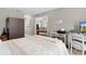 Bedroom with a queen bed, work space, and living room view at 17913 Se 88Th Cascade Ct, The Villages, FL 32162