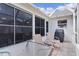 Screened patio with seating and grill at 17913 Se 88Th Cascade Ct, The Villages, FL 32162