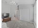 Cozy bedroom with a TV, closet, and carpeted flooring at 3162 Webster Way, The Villages, FL 32163