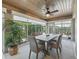 Sunroom with wood ceiling, dining table, and plenty of natural light at 3162 Webster Way, The Villages, FL 32163