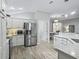 Modern kitchen with stainless steel appliances and white cabinets at 3162 Webster Way, The Villages, FL 32163