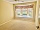 Spacious bedroom featuring a large bay window and plush carpeting at 1213 El Esparza Ln, The Villages, FL 32159
