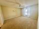 Spacious bedroom with plush carpeting and ceiling fan at 1213 El Esparza Ln, The Villages, FL 32159