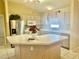 Kitchen boasts an island, stainless steel appliances, and ample counter space at 1213 El Esparza Ln, The Villages, FL 32159