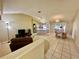 Open kitchen with island, dining area, and access to backyard at 1213 El Esparza Ln, The Villages, FL 32159