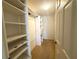 Large walk-in closet with shelving and hanging rods at 1213 El Esparza Ln, The Villages, FL 32159