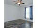 Bright bedroom featuring wood-look tile floors and blue curtains at 27231 White Plains Way, Leesburg, FL 34748