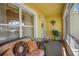 Relaxing front porch with wicker furniture and screened enclosure at 1213 El Esparza Ln, The Villages, FL 32159