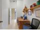 Home office features built-in shelving and a wood desk at 1213 El Esparza Ln, The Villages, FL 32159