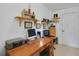 Home office with a wooden desk and ample storage at 1213 El Esparza Ln, The Villages, FL 32159