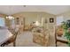 Spacious living room with a floral sofa and glass-top dining table at 1213 El Esparza Ln, The Villages, FL 32159