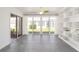 Sunroom with gray tile floors, built in shelving, and sliding glass doors at 306 Bishopville Loop # 117, The Villages, FL 32162