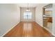 Bright dining room with hardwood floors and a view into the kitchen at 306 Bishopville Loop # 117, The Villages, FL 32162