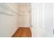 Spacious walk-in closet with wire shelving and wood flooring at 306 Bishopville Loop # 117, The Villages, FL 32162
