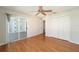 Bedroom with wood floors, ceiling fan, and built-in shelving at 306 Bishopville Loop # 117, The Villages, FL 32162